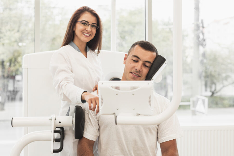 Dentista sorridente assistindo paciente em consulta de odontologia digital com tecnologia moderna; ambiente claro e acolhedor.